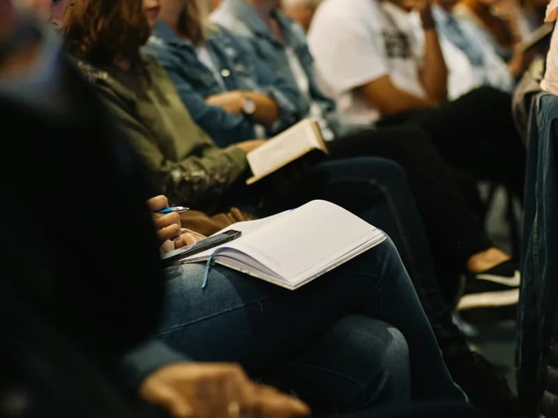 Attendees taking notes during a focused advisory board session.