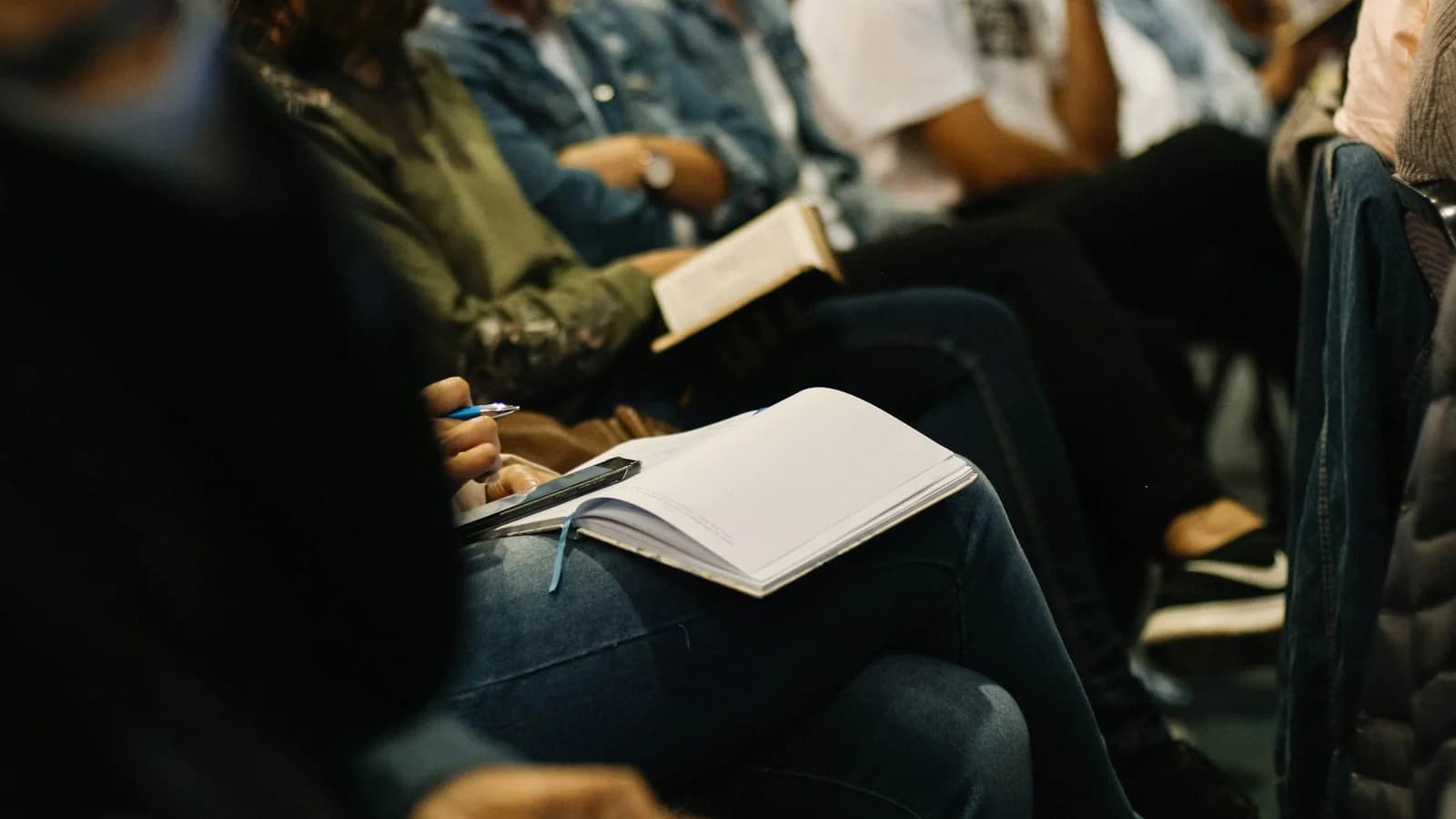 Attendees taking notes during a focused advisory board session.